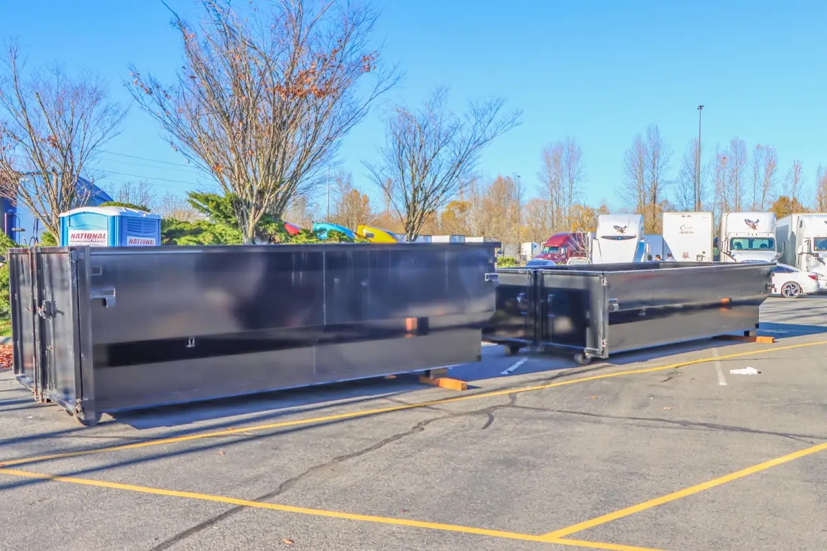 Professional dumpster rental service with roll-off container on residential driveway in Lake Lorraine